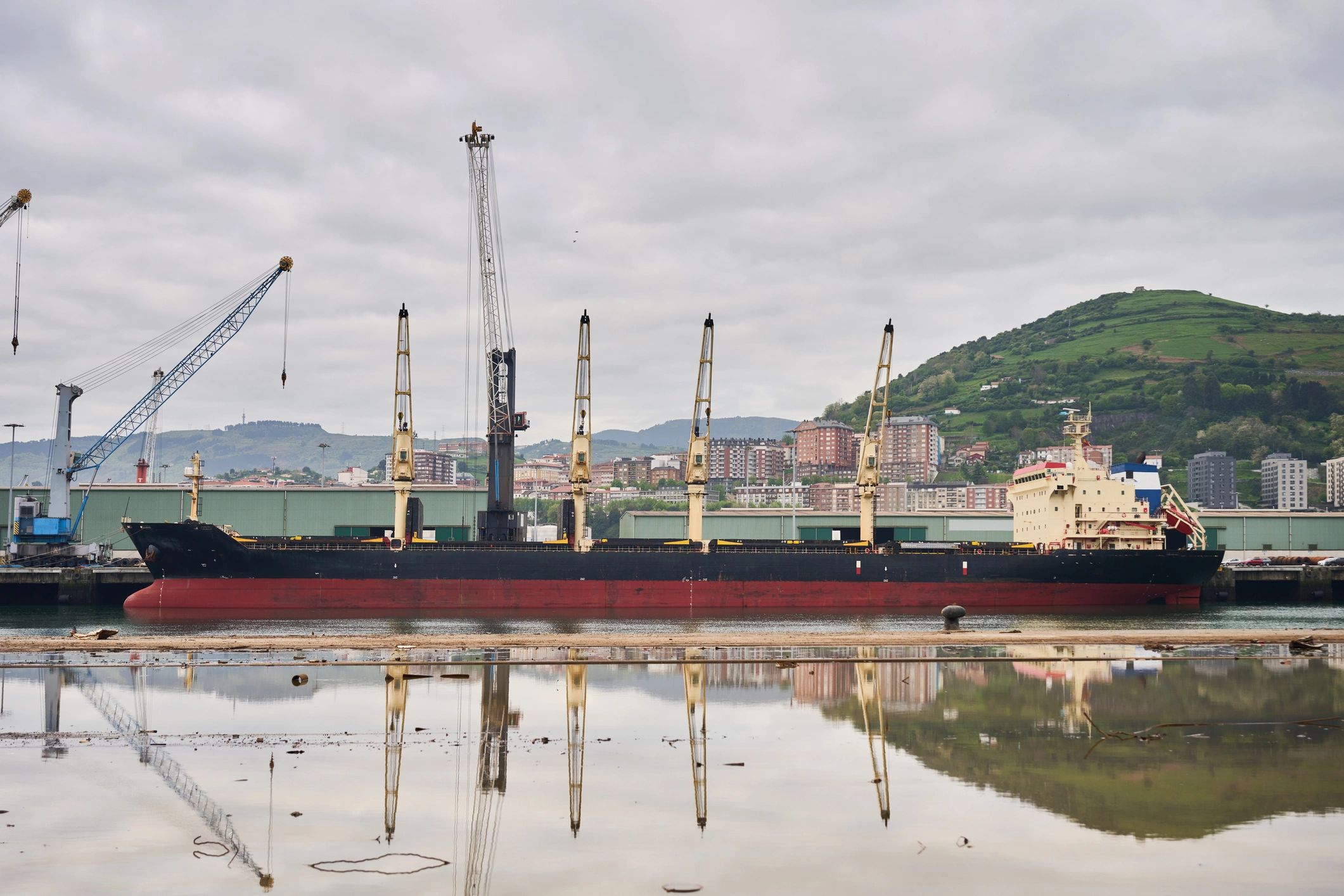 Bulk cargo ship at industrial port for export logistics